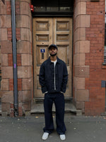 Load image into Gallery viewer, The Asili Mega baggy jeans in navy blue with silver embroidery
