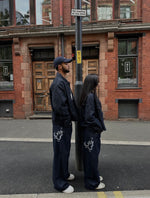 Load image into Gallery viewer, The Asili Mega baggy jeans in navy blue with silver embroidery
