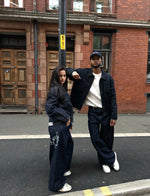 Load image into Gallery viewer, The Asili Mega baggy jeans in navy blue with silver embroidery
